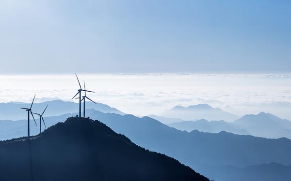 Stock photo - wind turbines above the clouds