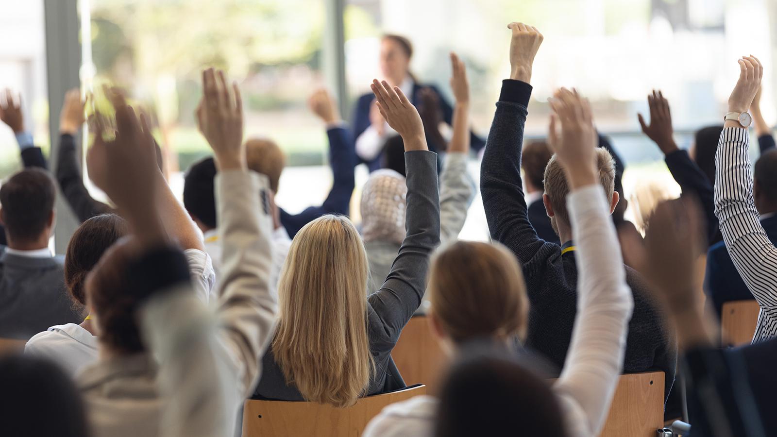 Stock photo - raised hands in question