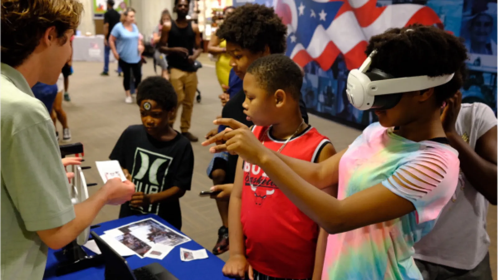 Gavin giving children a virtual reality demonstration. 