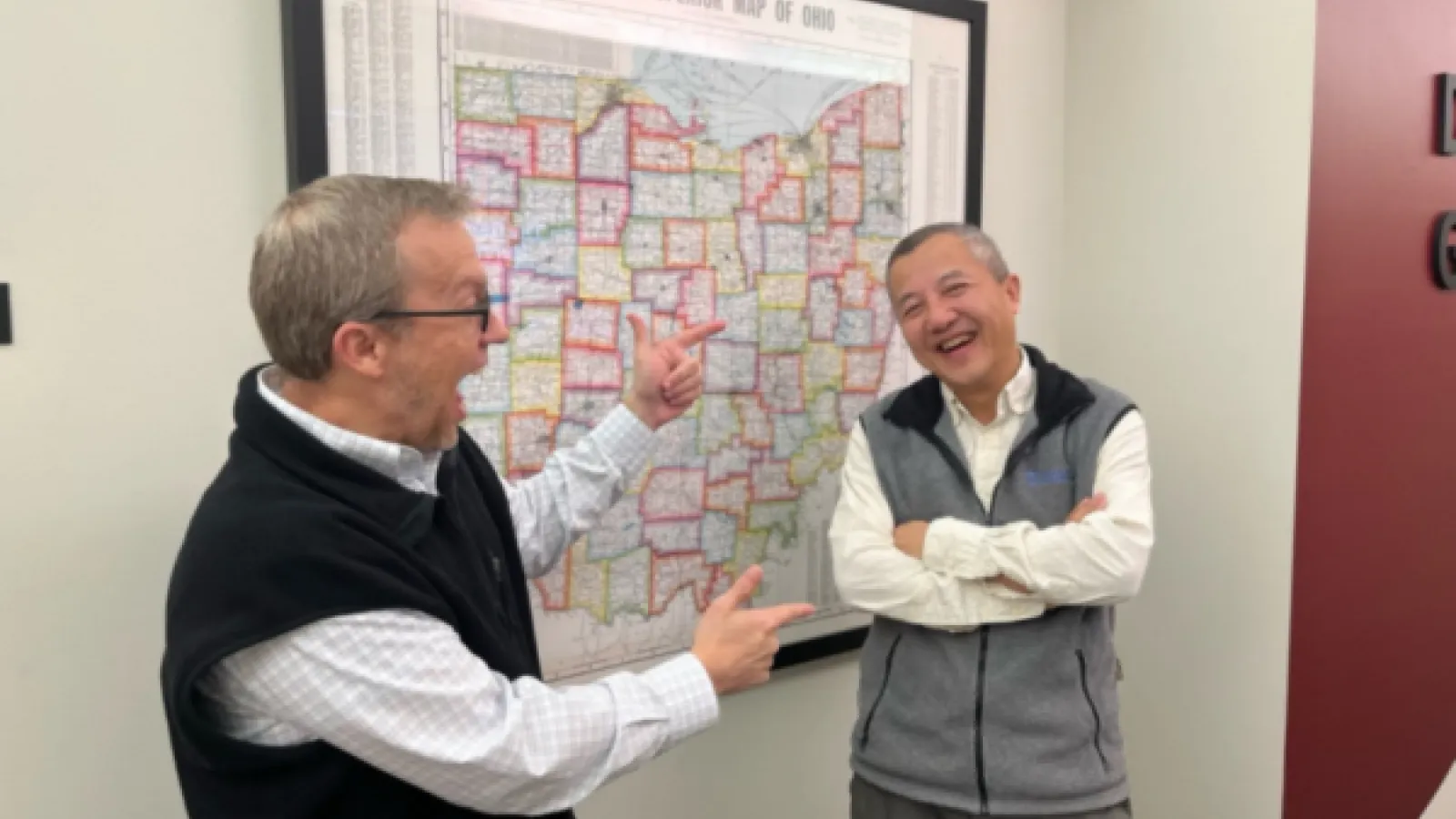 Steven Quiring pointed at a map with Zhengyu Liu