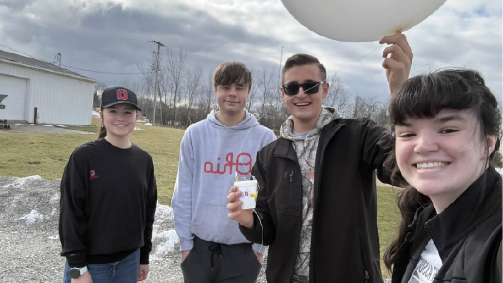 Students posing with weather balloon