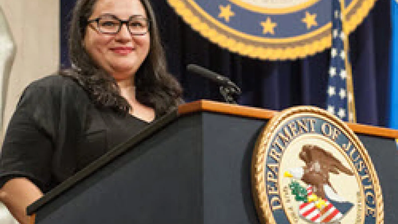 Picture of Naomi Adaniya on a presidential podium