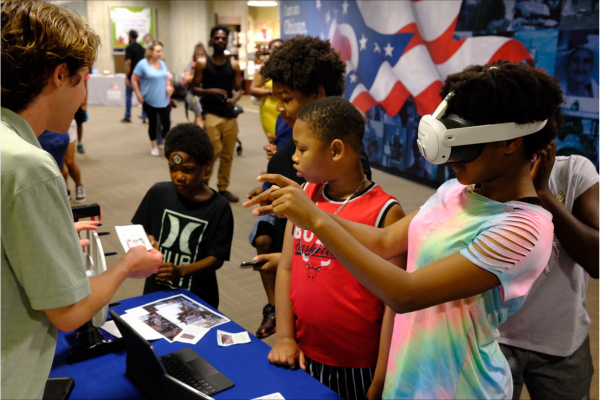 Gavin giving children a virtual reality demonstration.