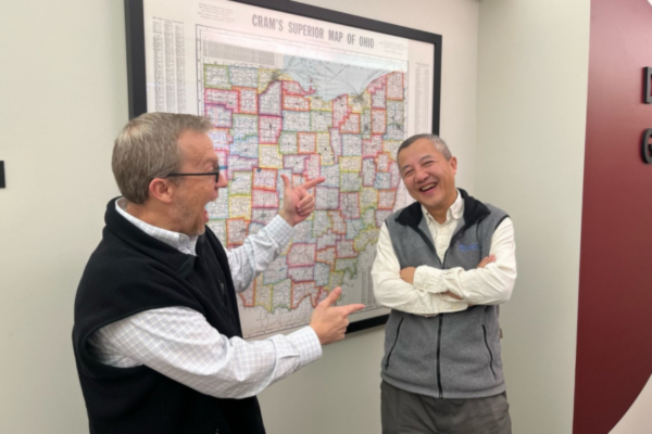 Steven Quiring pointed at a map with Zhengyu Liu