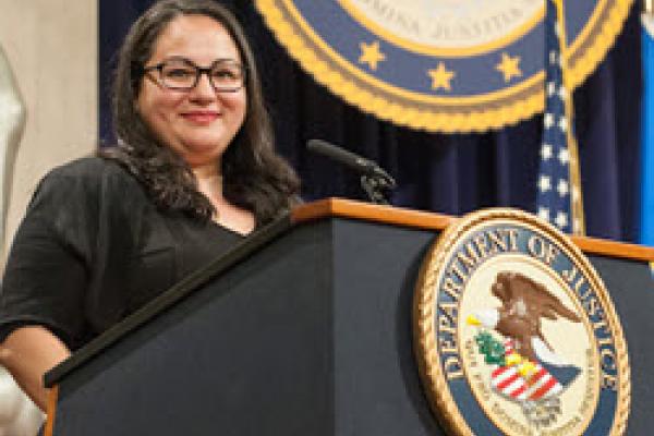 Picture of Naomi Adaniya on a presidential podium