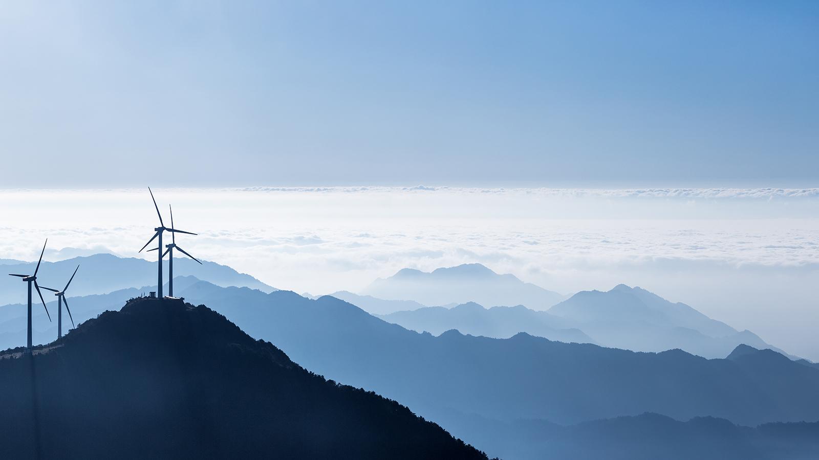 Stock photo - wind turbines above the clouds