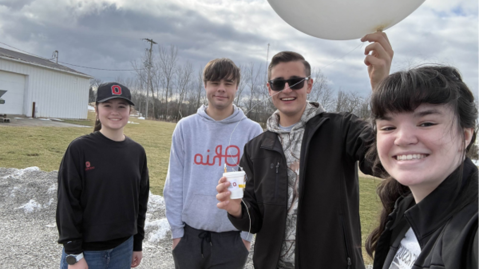 Students posing with weather balloon