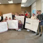 Students with posters in Derby Hall