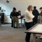 Megan Schaffer reading a poster