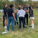 Students setting up field data equipment