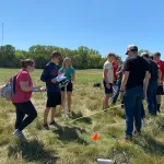 Students measuring for field equipment placement