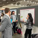 Logan Wallen and Yu Liu discuss their poster with AMS Attendee