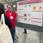 Joshua Steiner with his poster at AMS
