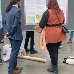 Kamran Chowdhury discussing poster with AMS Attendee