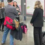 Yu Liu, Rachel Webb sharing their poster with AMS Attendee