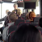 Carol Apacki talking to students on bus