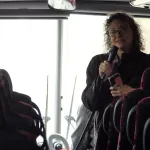 Dawn Burton talking to students on bus