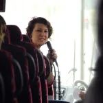 Allison Riggs talking to students on bus