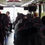 Allison Riggs talking to students on bus