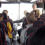Carol Apacki talking to students on bus