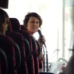 Allison Riggs talking to students on bus