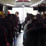 Allison Riggs talking to students on bus